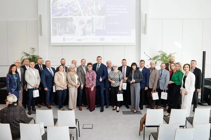 Grupa osób pozuje do pamiątkowego zdjęcia podczas konferencji o pożyczkach unijnych dla JST i biznesu w województwie lubuskim.